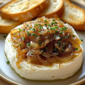 Creamy caramelized onion dip served with fresh vegetables and chips